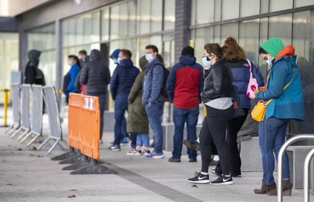 People queuing at the COVID-19 vaccination centre at Dundonald Hospital in Belfast, Northern Ireland.