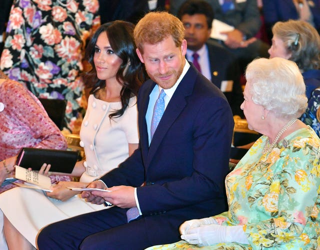 The Sussexes with Harry's grandmother the Queen in 2018