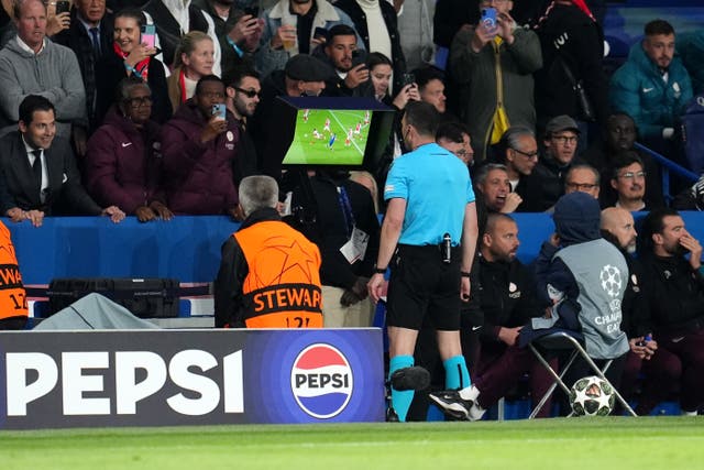 Referee Felix Zwayer consults the pitchside VAR before awarding a penalty kick to Paris Saint-Germain