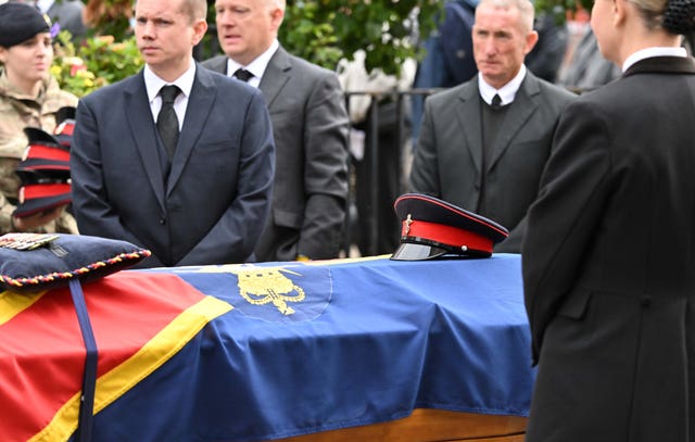 A military cap and medals laid on the coffin at the funeral of Norman Irwin