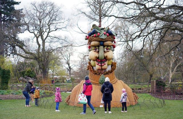 Families look at a sculpture at RHS Garden Wisley in Surrey