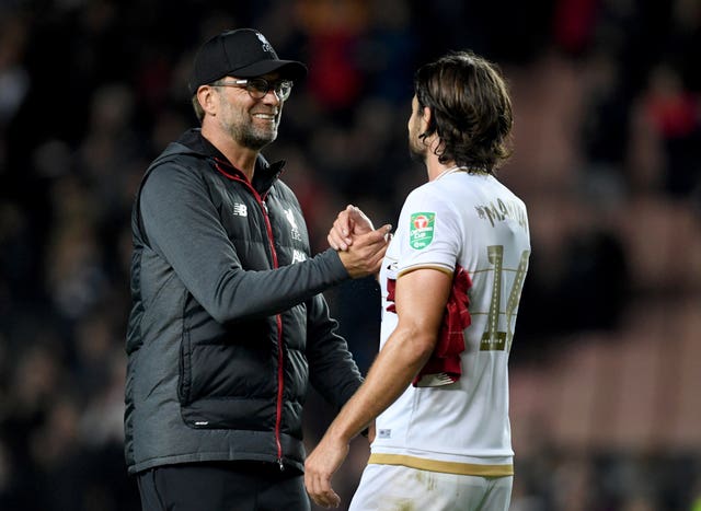 Jurgen Klopp (left) saw his side ease through