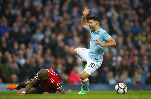 Sergio Aguero and Manchester United’s Ashley Young battle for the ball