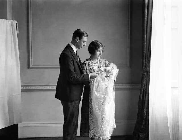 The Duke and Duchess of York (later King George VI and Queen Elizabeth) holding their baby daughter Princess Elizabeth (PA)