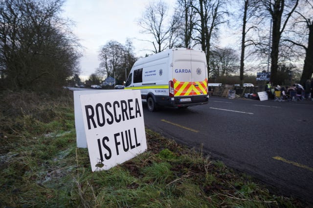 A Garda van passes protesters at the Racket Hall hotel in Roscrea, Co Tipperary