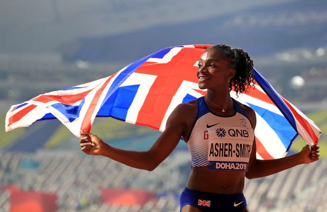 Dina Asher-Smith celebrates the silver medal