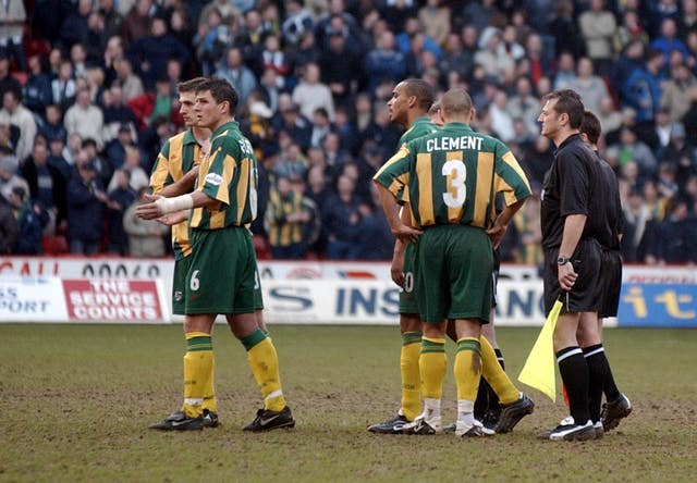 West Brom players react as referee Eddie Wolstenholme abandons the game