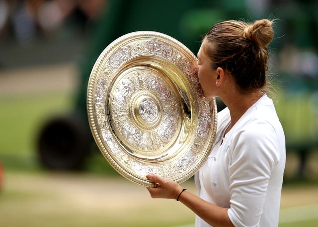 Sealed with a kiss: Halep gets her hands on the trophy for the first time 