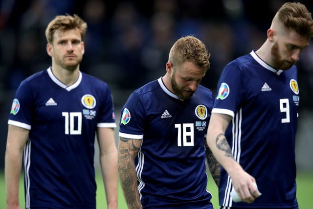 Stuart Armstrong, Johnny Russell and Oli McBurnie, l-r, react to defeat in Astana