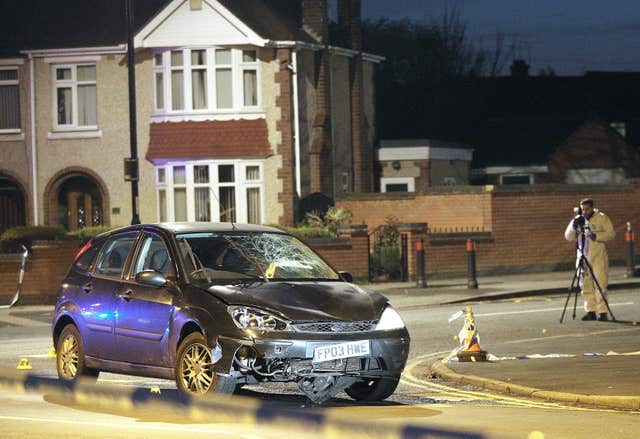 A forensic officer at the scene of the crash