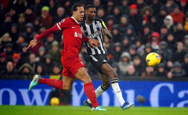 Newcastle's Alexander Isak, right, scores under pressure from Liverpool captain Virgil van Dijk