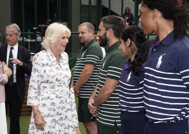 The Queen speaks to Robin Murphy, lead gardener, who has recently celebrated 20 years of service and has been working diligently to maintain the more than 50,000 plants during the recent hot weather, at the All England Lawn Tennis and Croquet Club on day 10 of the 2025 Wimbledon Championships