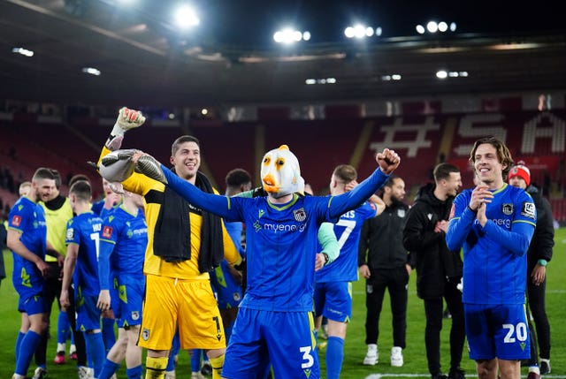 Anthony Driscoll-Glennon, centre, wears a fish mask as Grimsby celebrate their FA Cup win at Southampton