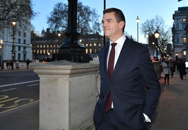 Sir Olly Robbins walking outside on Whitehall