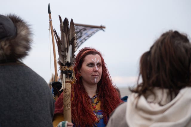 Re-enactors prepare to burn a longboat