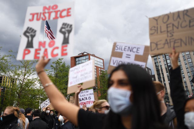 People take part in a Black Lives Matter protest rally at the US Embassy, London