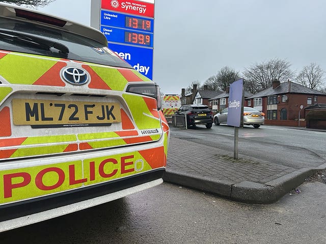 Police near to the scene where a red Seat Leon collided with a Citroen C4 Picasso taxi on Wigan Road in Bolton