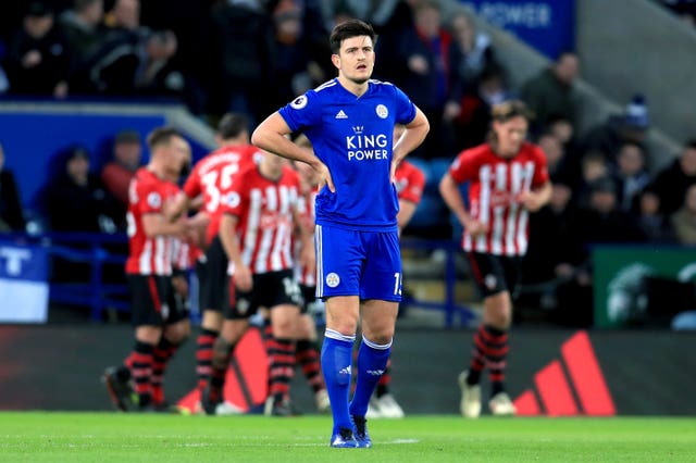 Harry Maguire appears dejected as Shane Long (back) scores Saints' second goal