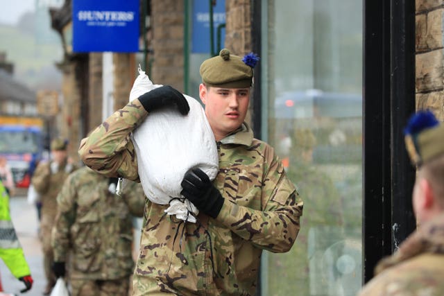 Soldier carrying a sandbag