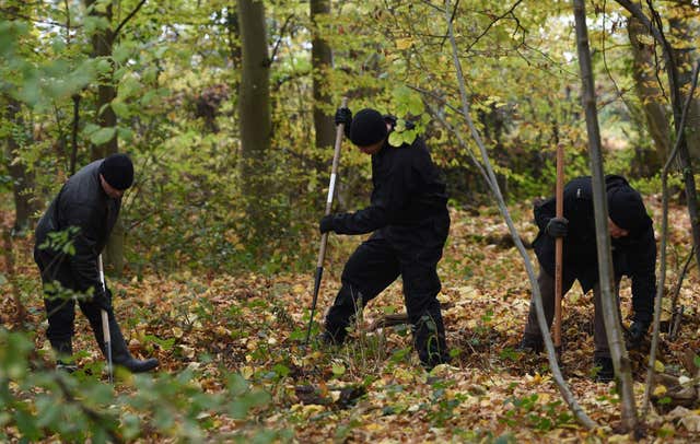 Police officers search an area of Coombe Country Park (Joe Giddens/PA)