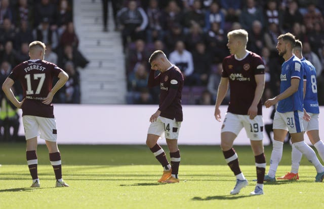 Cameron Devlin, second left, leaves the field after his red card