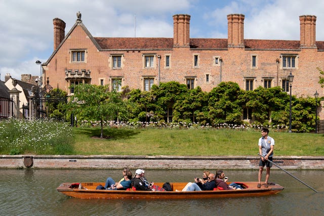 People enjoy a punt tour along the River Cam in Cambridge (Joe Giddens/PA)