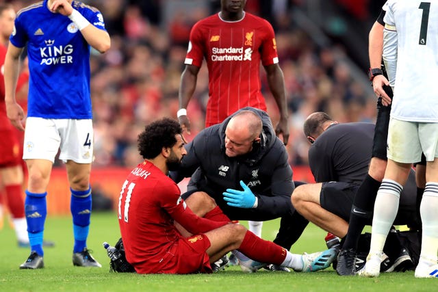 Liverpool's Mohamed Salah receives treatment after a tackle from Hamza Choudhury