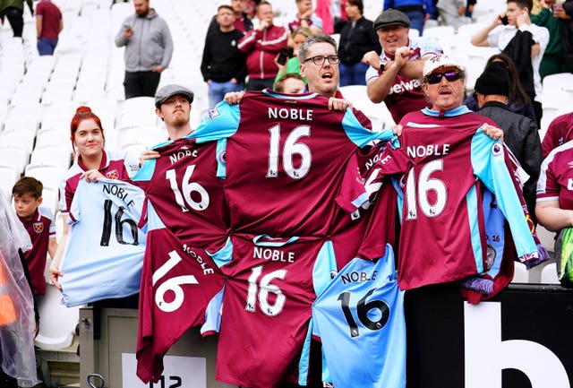 West Ham fans hold up their Mark Noble shirts after a presentation to mark his last home game for the club 