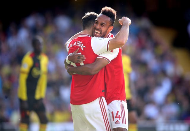 Pierre-Emerick Aubameyang, right, celerates with Sead Kolasinac after his first goal against Watford