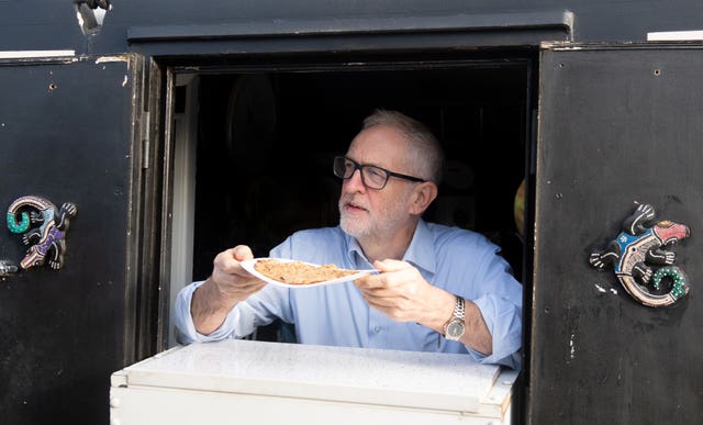 Jeremy Corbyn serves oatcakes during a visit to The Oatcake Boat owned by Kay Mundy, in Stoke-on-Trent