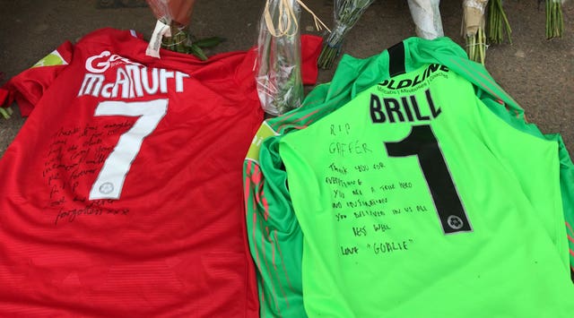Leyton Orient captain Jobi McAnuff and goalkeeper Dean Brill lay their shirts in the Orient dugout in tribute to former manager Justin Edinburgh, whose death at the age of 49 was announced on Saturday