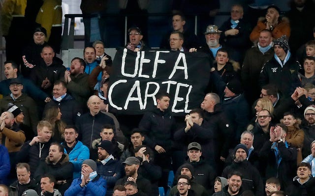 City fans hold up a sign at the Etihad Stadium