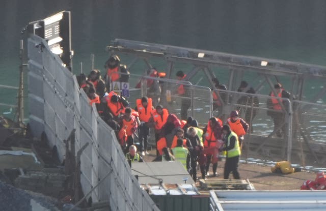 A group of people thought to be migrants are brought in to the Border Force compound in Dover, Kent, from a Border Force vessel