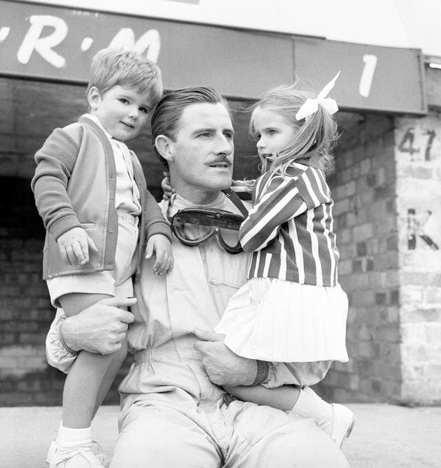 Reigning world champion Graham Hill takes time out with son Damon and daughter Brigitte during practice for the 1963 British Grand Prix. Fellow Briton Jim Clark won the race en route to taking Hill's world title