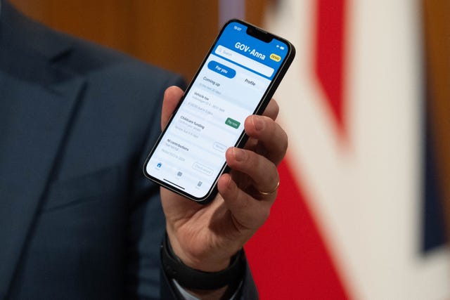 Darren Jones holds a phone with his prototype Gov.uk app