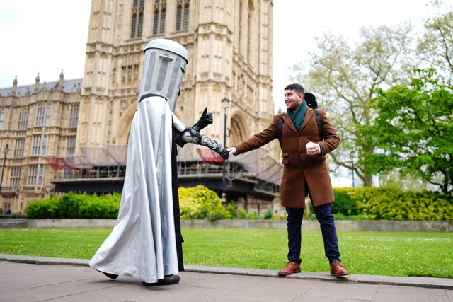 Mayor of London election candidate Count Binface greets an admirer outside Parliament