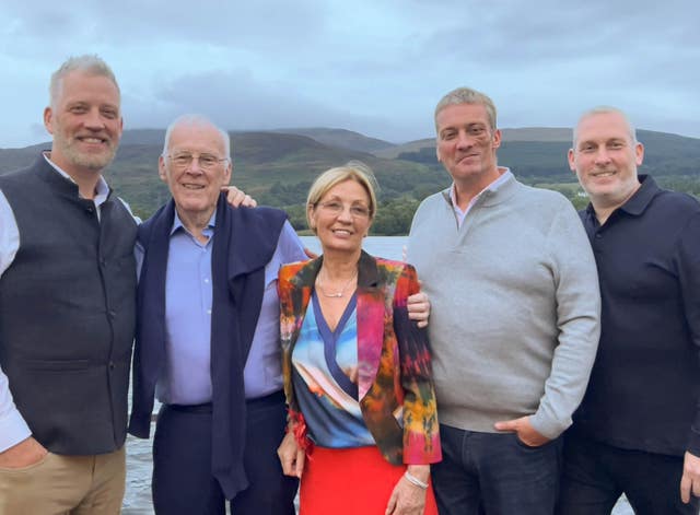 Sir Ian Wood stand with a group of people