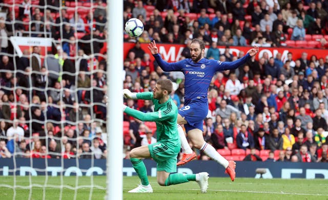 Gonzalo Higuain has a shot saved by David De Gea