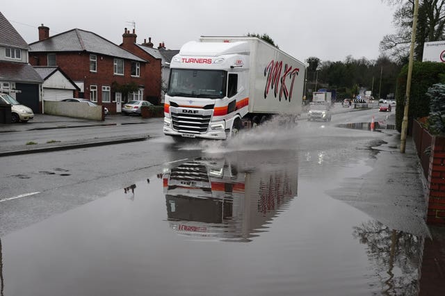 A lorry driving through flood water on a residential road in Halesowen