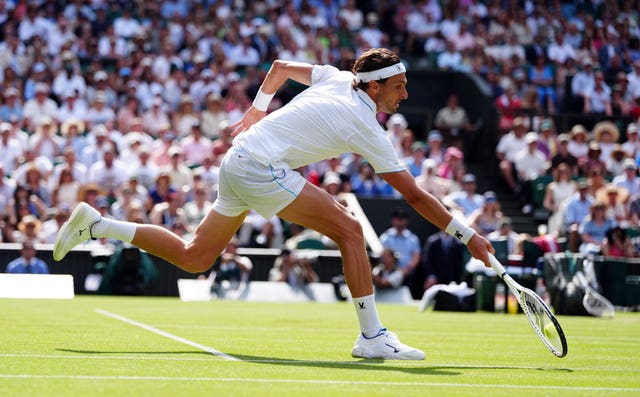 Arthur Rinderknech stretches to hit a forehand