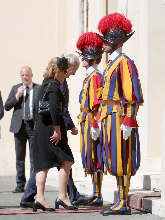 Taoiseach Micheal Martin and his wife Mary walk past the Swiss Guards as they arrive in the San Damaso Courtyard