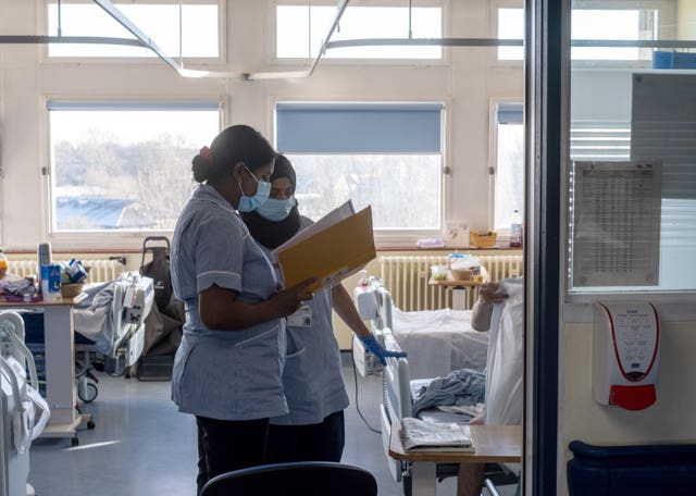 NHS staff looking at patient records on an NHS ward