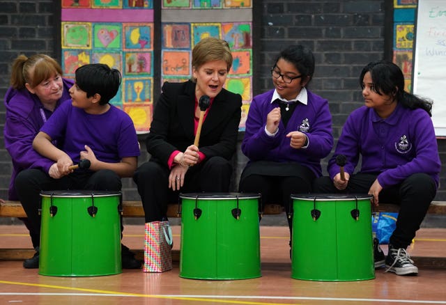 Nicola Sturgeon plays the drums during her school visit