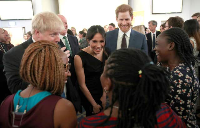 Foreign Secretary Boris Johnson, Prince Harry and Ms Markle speak to guests (Chris Jackson/PA)