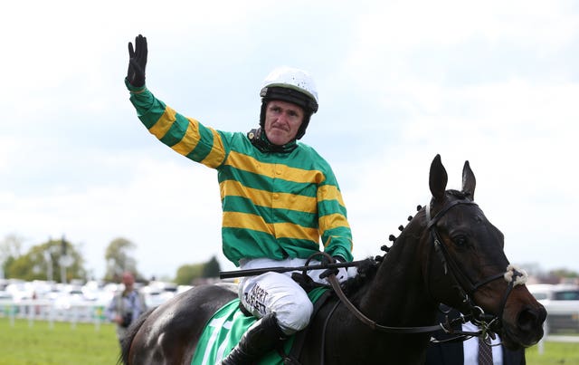 Sir Anthony McCoy waves to the crowd following his last ever ride 