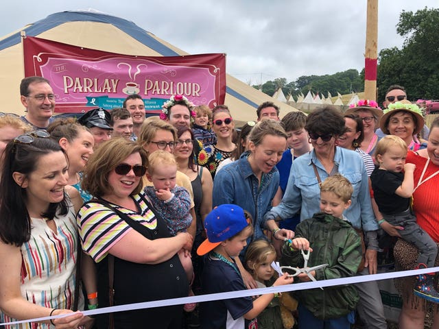 Emily Eavis, centre, opening the new Parlay Parlour in The Park on the first day of the Glastonbury Festival at Worthy Farm in Somerset