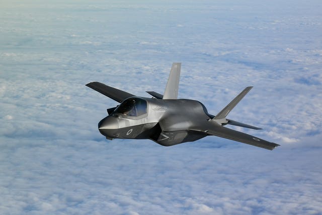 An RAF F-35 jet flies above the clouds