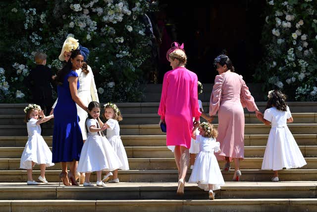 Mulroney, second left, holds bridesmaids' hands as they arrive for Meghan and Harry's wedding
