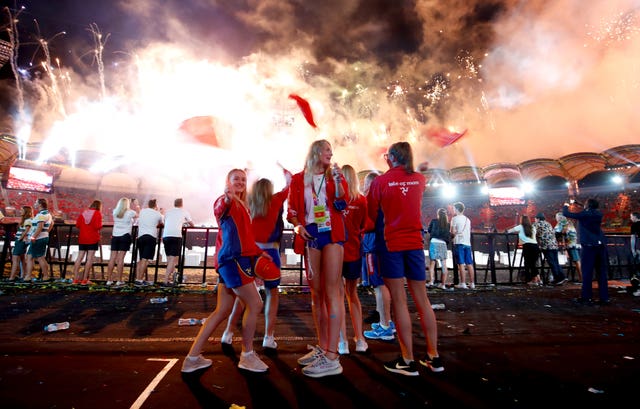 Isle of Man athletes wave flags in the closing ceremony in Australia's Gold Coast (Martin Rickett/PA)