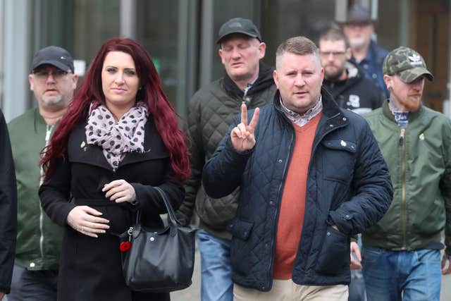 Britain First leader Paul Golding leaves Belfast Laganside Court showing the V-sign with deputy leader Jayda Fransen and supporters after a previous court hearing (Liam McBurney/PA)